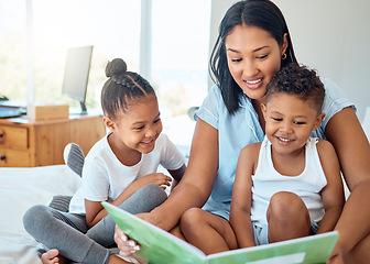 Image showing Mother reading a book to her children in a bedroom to relax, bond and learn in their family home. Happiness, education and woman doing storytelling with her kids while relaxing on a bed in a house.