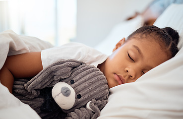 Image showing Peace, morning and wellness of black child sleeping in cozy bed with toy teddy in home on the weekend. Relax, sleep and health of kid dreaming in comfortable home bedroom with teddy bear.