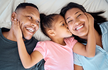 Image showing Happy family, kid kiss and bed with a girl, mother and father with a smile, love and parent care. Happiness, hug and black family in a bedroom lying relax together in a morning with a child at home