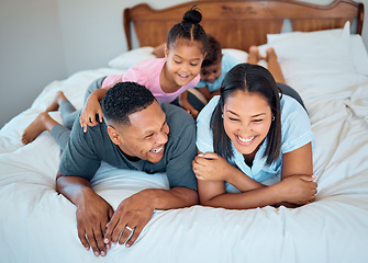 Image showing Happy family with kids, smile and lying on bed in home, mother and father with children together in Mexico. Love, fun and family time for dad, mom and babies playing in family bedroom on weekend.