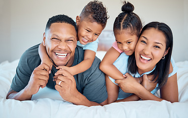 Image showing Happy, love and family with a smile on a bed to relax together in bedroom of their house. Happiness, father and mother laying in the room with children while bonding, relaxing and having fun at home.