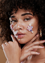 Image showing Flowers, skincare and woman in studio for beauty, grooming and facial with product from nature, organic and eco friendly. Portrait, black woman and face of hair model with flower, plant and wellness