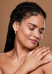 Image showing Black woman, skincare and face with smile in relax for cosmetics or makeup against a brown studio background. African American female touching shoulder in satisfaction for soft beauty skin treatment