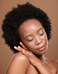 Image showing Black woman afro, skincare and face with smile for cosmetics, beauty or makeup against a brown studio background. African American female relax in wellness for luxury facial, hair or skin treatment