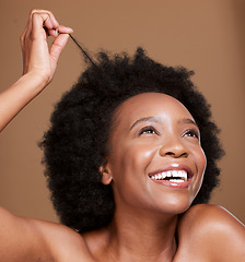 Image showing Black woman, afro and hair care, beauty and skincare for body wellness, cosmetics and curly hair maintenance on studio background. Happy, smile and young african girl model, hairstyle strand and face