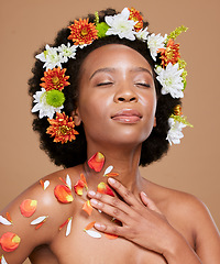 Image showing Flower, beauty and woman in studio with a crown for skincare, dermatology and nature product on brown background. Black woman, plant and flowers facial by wellness model, cosmetic and petal aesthetic