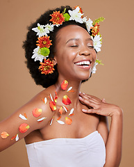 Image showing Black woman, happy and flowers in studio for wellness, pamper and nature product against brown background. Smile, girl model and flower, crown and cosmetics for beauty, zen and aesthetic with mockup