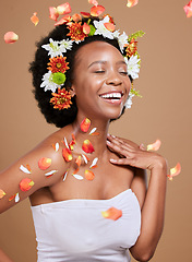 Image showing Art, flowers and woman with crown in studio for hair, wellness and skincare, beauty and plant product on brown background. Happy, black woman and flower crown by girl model excited by nature cosmetic