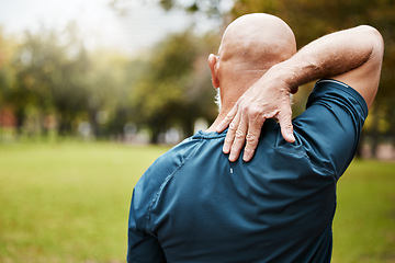 Image showing Exercise, fitness and back pain of senior man at outdoor park after bad workout. Mature male runner with hand on spinal injury, fibromyalgia and muscle pain after cardio, running or training in natur