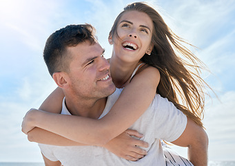 Image showing Love, piggyback and happy couple at the beach on vacation while bonding together in Australia. Happiness, care and young man and woman on a seaside, ocean and summer adventure, holiday or journey.