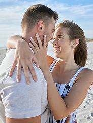 Image showing Love, couple close and hug on beach with smile, romantic and on sand being loving, on holiday and together. Romantic man and woman embrace for relationship, getaway and seaside vacation to celebrate.