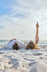 Image showing Beach, relax and couple watching the sky while on a seaside vacation, adventure or journey. Travel, calm and man and woman resting together in nature by the ocean while on holiday in Australia.