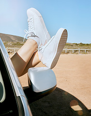 Image showing Relax, woman feet out of window and road trip in nature, enjoying freedom of travel in car on summer vacation. Blue sky, journey and shoes out of car window, adventure drive in African countryside.