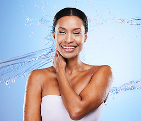 Image showing Portrait, skincare and water splash of woman in studio on a blue background. Hygiene body care, cleaning and female model from India showering, bathing or washing skin for health, wellness and beauty