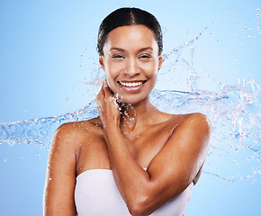 Image showing Black woman, water splash and woman skincare moisturizing skin, natural body wellness and liquid detox cleaning routine. Sustainable cosmetics health, washing skin and smile on a blue wall background