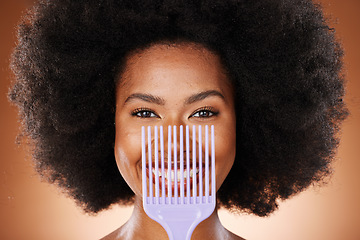 Image showing Hair care, comb and black woman with smile, natural beauty and skincare against brown studio background. Cosmetics, beautician and African American woman with afro, combing and happy with portrait.