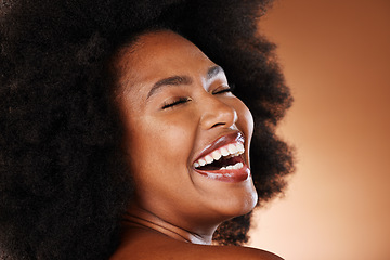 Image showing Black woman, afro hair and laughing face expression on studio background in self love, empowerment or acceptance. Zoom, smile or happy beauty model with natural hair, white teeth and makeup cosmetics