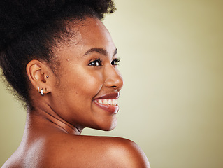 Image showing Skincare, beauty and black woman in a studio for a health, wellness and cosmetic face routine with mockup space. Happy, smile and African model with a natural facial treatment by a green background.
