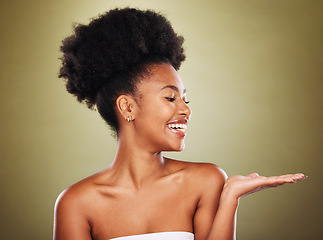 Image showing Black woman, skincare and hand open gesture in studio while happy, healthy and smile with radiant glow on skin. Model, girl and palm with happiness, cosmetics and makeup for wellness against backdrop