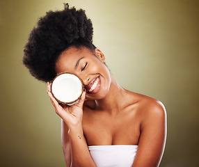 Image showing Black woman, coconut and beauty in studio for skincare, health and wellness by cosmetic backdrop. Happy african model, woman or fruit for healthy glow, natural cosmetics or nutrition by background
