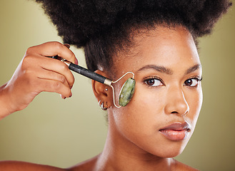 Image showing Roller, black woman facial beauty or model for skin healthcare, wellness or cosmetics makeup in studio. Luxury, confident portrait or girl face for massage, health or aesthetic skincare routine