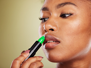 Image showing Lipstick, black woman and mouth, makeup and skincare, cosmetics and aesthetics on green studio background. African model face, advertising beauty product and lip color, luxury fashion and lip balm