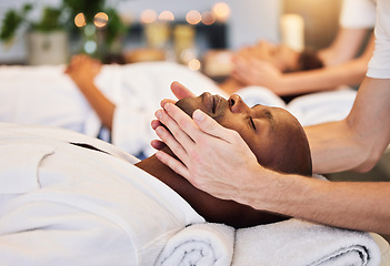 Image showing Face massage, beauty therapist and black man, skincare and relax in luxury spa with zen, hands and rest on a bed. Wellness, skin health and cosmetic treatment for healthy skin and relaxing body