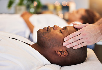 Image showing Black man, relax and head massage with therapist hands in a luxury spa, wellness and skincare on a bed. Masseur with relax client in zen, calm or peace luxury hotel salon for physical body therapy