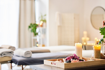 Image showing Candle, spa and relax with aromatherapy treatment in a tray in a room for luxury or wellness. Background, health and massage with still life in an empty resort for peace, skincare or relaxation