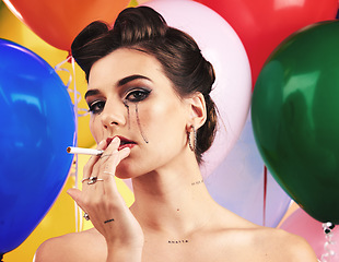 Image showing Makeup, beauty and smoking with a model woman in studio on a balloon background for nicotine addiction. Portrait, cosmetics and cigarette with a female posing to promote a tobacco smoke product