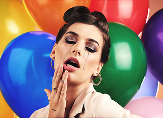 Image showing Woman, balloon and sad cry in studio with makeup tears, depression or anxiety at birthday. Mental health model, party or depressed by balloons, frustrated mascara crying or moody with stress at event