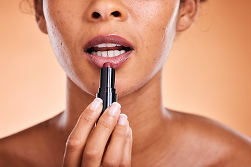 Image showing Lipstick, black woman and cosmetics for skincare, natural beauty and wellness against brown studio background. Makeup, female and girl with lip gloss for soft lips, mouth and smooth facial for lady.