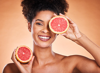 Image showing Grapefruit, skincare and portrait of black woman with a beauty, organic and natural routine. Cosmetics, citrus fruit and African model with cosmetic facial treatment in studio with orange background.