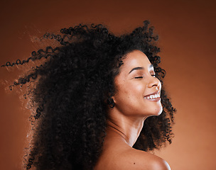 Image showing Hair care, black woman and cosmetics with smile, happy and relax on brown studio background. Makeup, African American female or girl with afro, confidence or organic facial or face detox for skincare