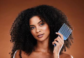 Image showing Hair, comb and beauty with a black woman model in studio on a black background for haircare or treatment. Portrait, face and afro with an attractive young female posing to promote keratin hair care