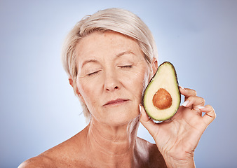 Image showing Mature, beauty and skincare with a woman and an avocado for smooth, soft skin on a grey background. Anti aging, skin care facial treatment with fresh food for senior female with avo for health