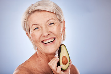 Image showing Senior woman with avocado, natural skincare for plant based product with healthy ingredient. Portrait of happy elderly lady, smile with fruit for face mask and vegan cruelty free lifestyle in studio