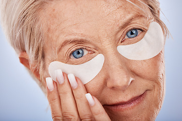 Image showing Face, beauty and eye mask with a senior woman in studio on a gray background for antiaging treatment. Portrait, cosmetics and wrinkles with a mature female posing to promote a natural product