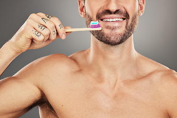 Image showing Health, dental or man with toothbrush for teeth, dental hygiene or happy face on a grey studio background. Oral, smile or face zoom portrait of healthy male with brush for healthcare wellness model