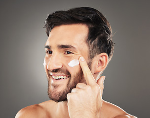 Image showing Beauty, sunscreen and face of man with cream product for health, moisturizing and skin hydration. Happy, healthy and skincare lifestyle routine of model on dark gray studio background.