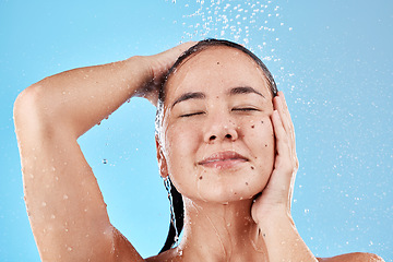 Image showing Beauty, skincare and hair, woman in shower on blue background, haircare and hygiene routine in the morning. Model in water splash, cleaning hair and face with running water for clean fresh lifestyle.