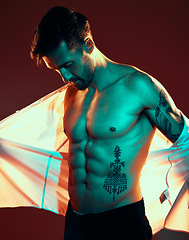 Image showing Man, tattoo and shirtless body in studio with fitness, health and beauty with light, glow and sexy. Model, six pack and body art ink for healthy skin, cosmetics and fashion while trendy, edgy or hot