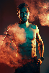 Image showing Fitness, body and man in a studio with smoke or mist after an intense workout or bodybuilding training. Sports, health and portrait of a bodybuilder or athlete with muscle isolated by dark background