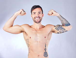 Image showing Bodybuilder, man and flex body, smile for wellness, after fitness and training with grey studio background. Muscles, arms and healthy man with motivation, workout and happy with progress and portrait