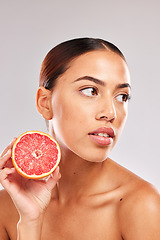 Image showing Skincare, beauty woman with grapefruit in hand for wellness healthcare, cosmetic health or skin luxury in studio. Face of girl skin, healthy diet with vitamins, food or fruit for nutrients