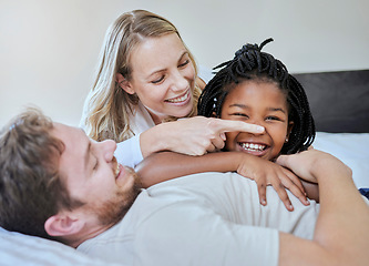 Image showing Black girl, child or parents bonding on bed in house, home or hotel in fun game or activity. Smile, happy or laughing kid with mother, father with foster or interracial family in relax bedroom