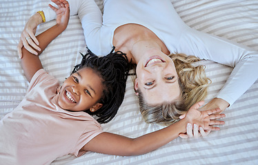 Image showing Mother, adoption and child lying on bed with smile for quality family bonding time together at home. Happy mom holding adopted kid smiling and relax in happiness for playful fun in the bedroom above