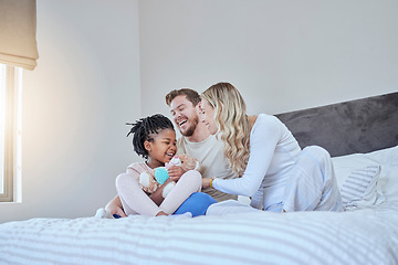 Image showing Interracial, adoption family and bed with smile, happiness and bonding together with kid, home and love. Diversity, happy family and sitting in bedroom with child, african girl and parents in house