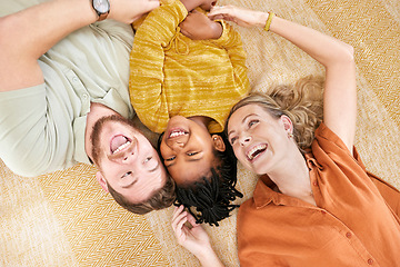 Image showing Interracial family, adoption and home on floor with head together for love, happy and bonding. Mom, dad and african girl child lying with smile, happiness and diversity on carpet with top view