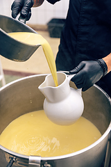 Image showing Chicken broth pours into the serving jug